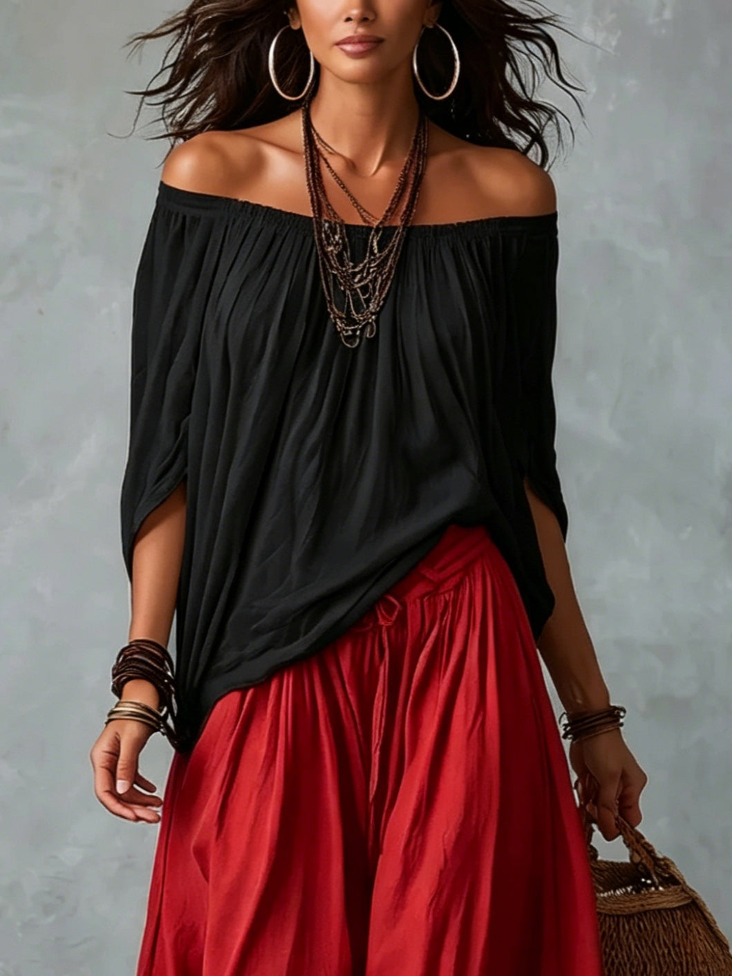 Conjunto de top negro con hombros descubiertos y pantalón de linterna amplio rojo