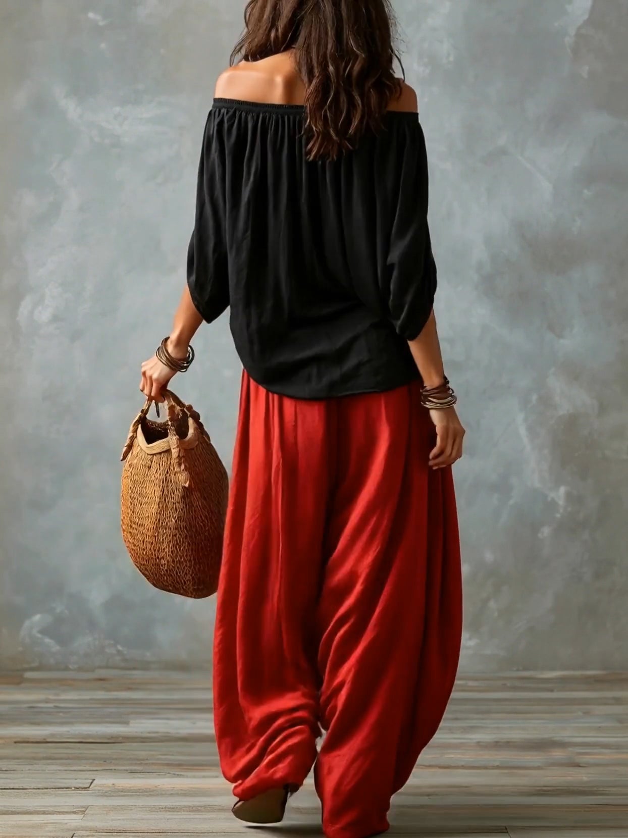 Conjunto de top negro con hombros descubiertos y pantalón de linterna amplio rojo